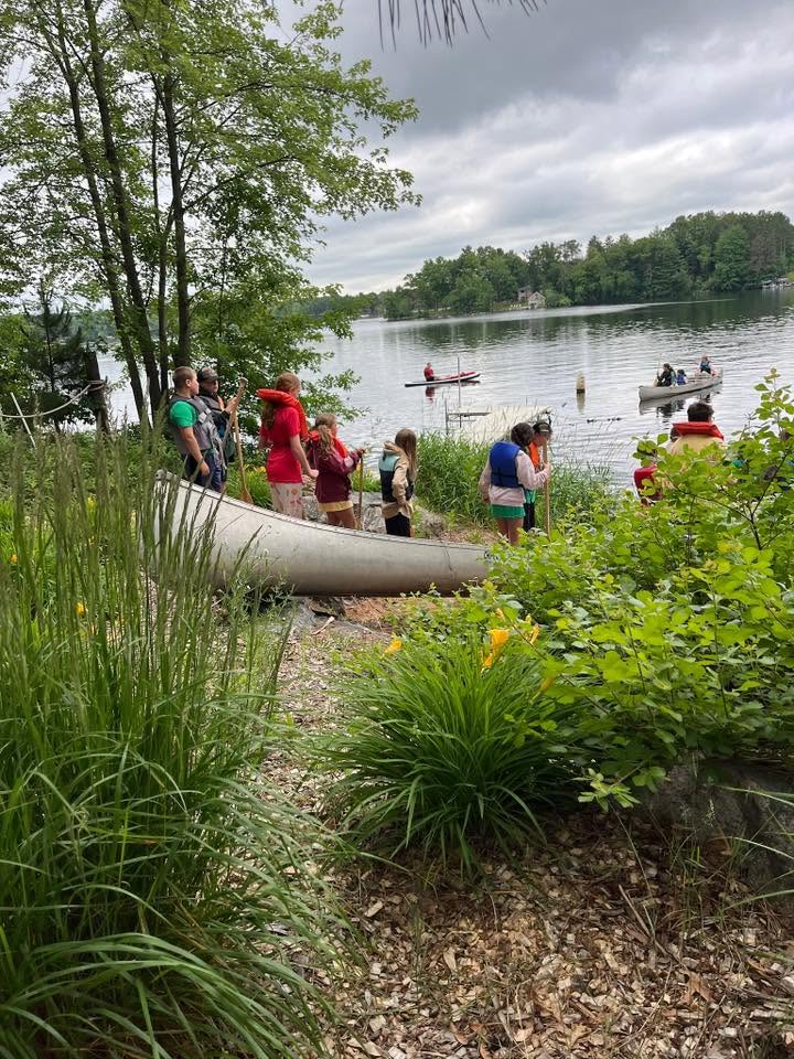 campers awaiting to load their canoe into the water